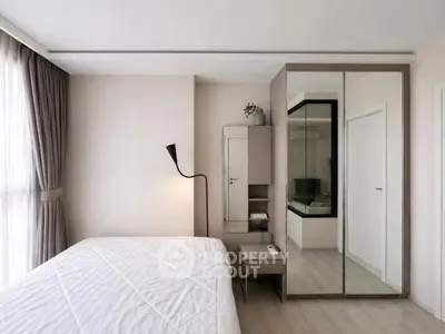 Modern bedroom with mirrored wardrobe and elegant floor lamp