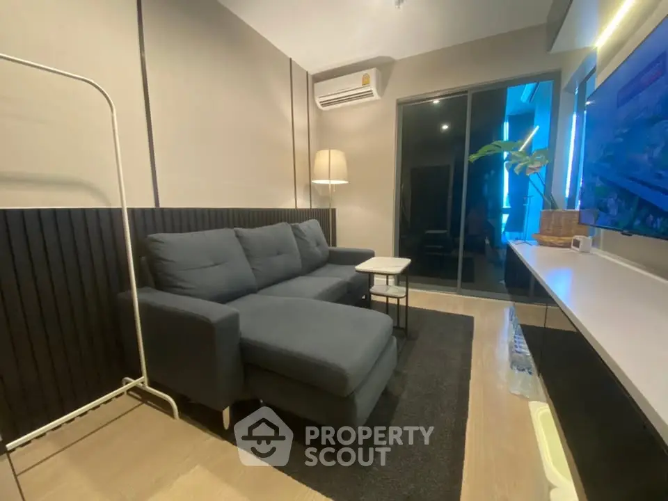 Modern living room with sleek furniture and ambient lighting, perfect for relaxation and entertainment.