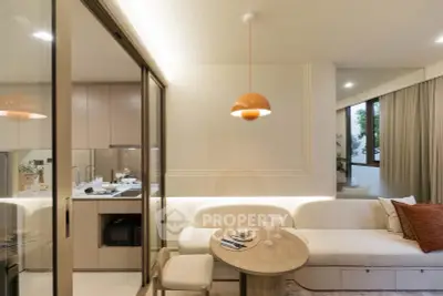 Modern open-plan living room with cozy seating and stylish kitchen area