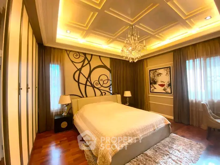 Luxurious bedroom with elegant chandelier and artistic wall decor