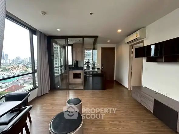Modern living room with city view and sleek wooden flooring