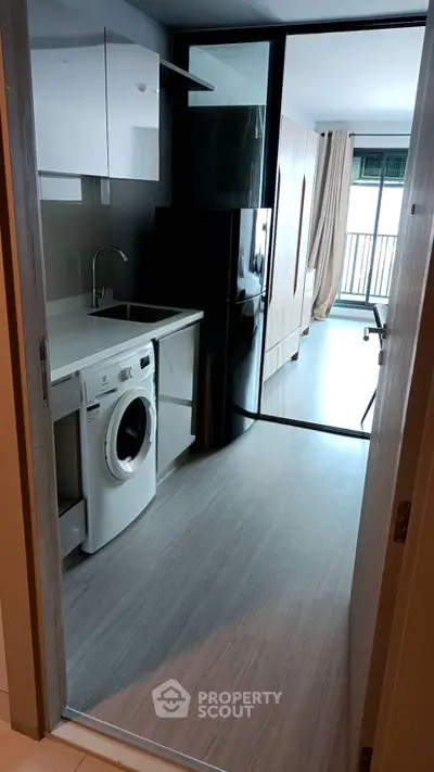 Modern apartment interior with kitchen appliances and balcony view