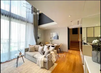 Luxurious modern living room with high ceilings and elegant decor in a stylish apartment.