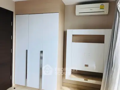 Modern bedroom with sleek built-in wardrobe and air conditioning unit