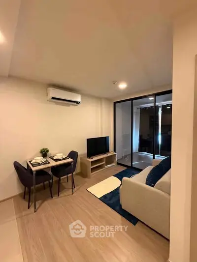 Modern living room with cozy seating and dining area, featuring sleek air conditioning and stylish decor.