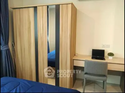 Modern bedroom with wooden wardrobe and cozy study desk setup