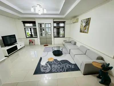 Spacious modern living room with stylish decor and ample natural light