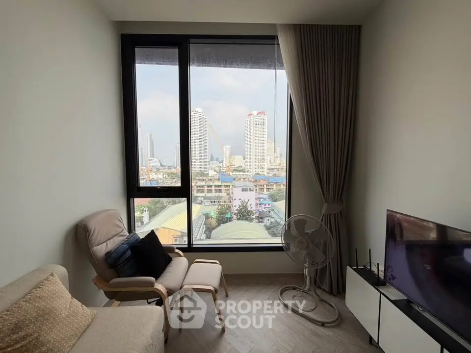 Modern living room with city view, featuring cozy seating and large windows.