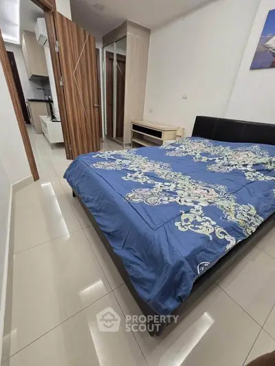 Modern bedroom with stylish decor and mirrored wardrobe in a contemporary apartment.