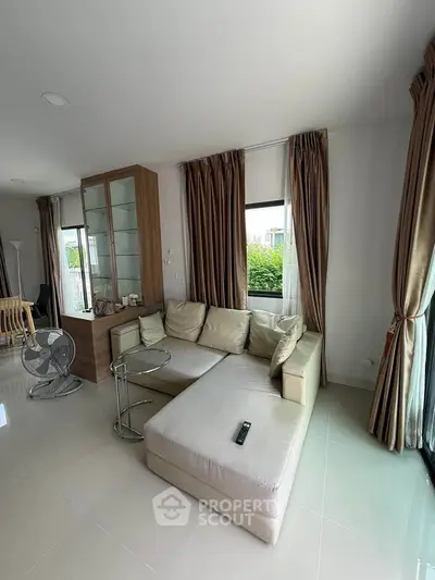 Spacious living room with modern sofa and large windows for natural light