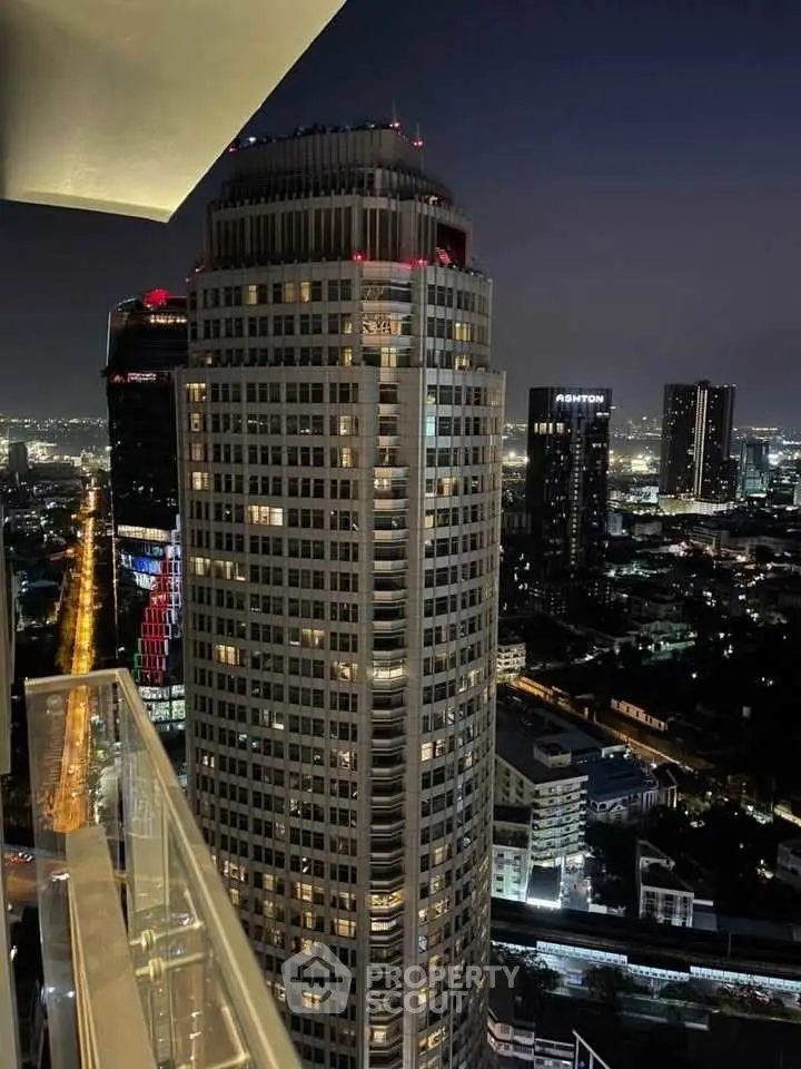 Stunning night view of city skyline from high-rise balcony, showcasing urban elegance.