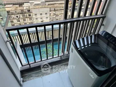 Charming balcony with pool view and washing machine, perfect for urban living.