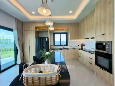 Luxurious modern kitchen with island, sleek cabinetry, and stunning outdoor view