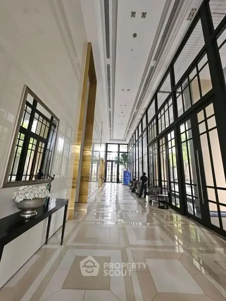 Luxurious building entrance with high ceilings and elegant decor