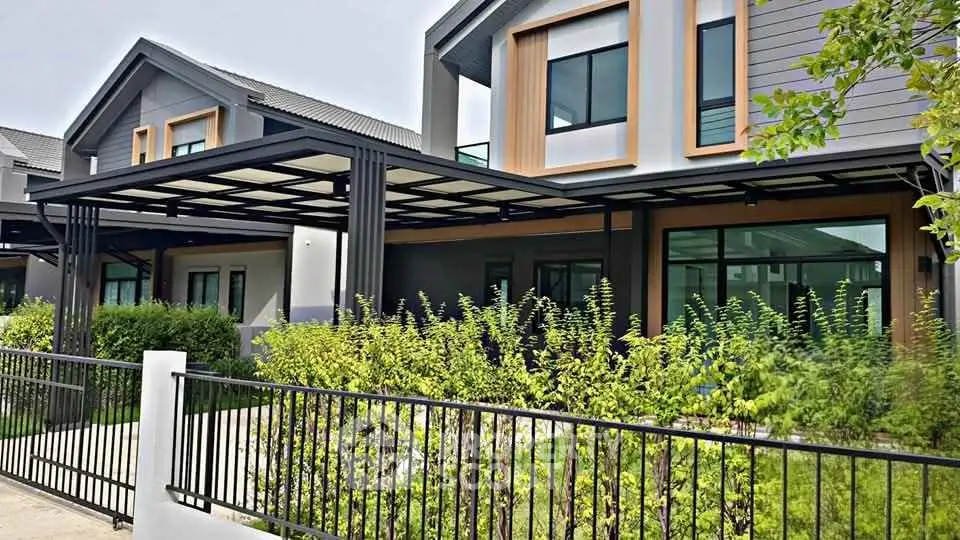 Modern townhouse exterior with sleek design and lush greenery