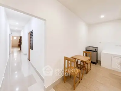 Spacious kitchen with wooden dining set and modern appliances in bright apartment