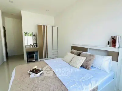 Bright and cozy bedroom with modern decor and ample natural light.