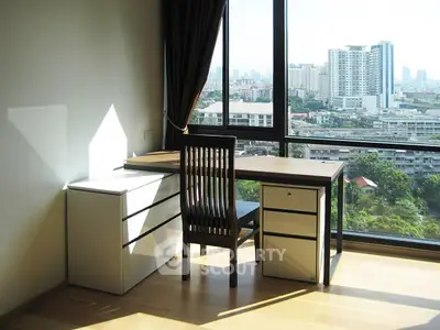 Bright study room with city view, modern desk and chair, large windows.
