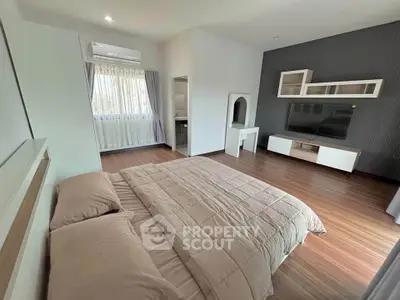 Spacious modern bedroom with stylish decor and natural light
