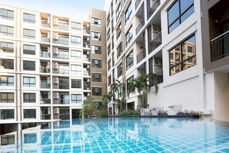 Modern condominium with luxurious pool and contemporary architecture.