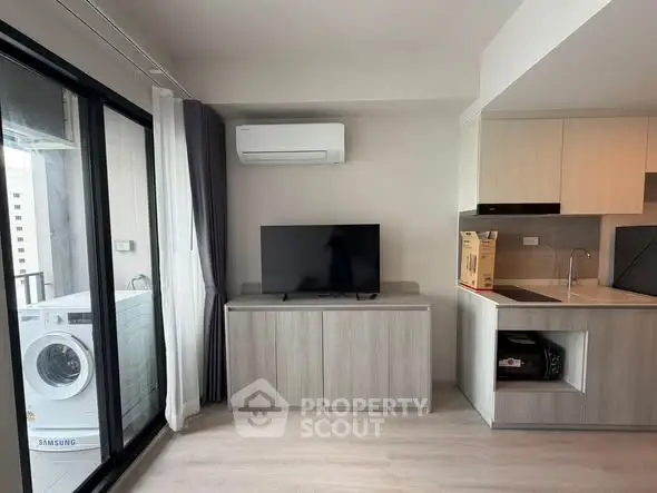 Modern living room with sleek kitchen and balcony view