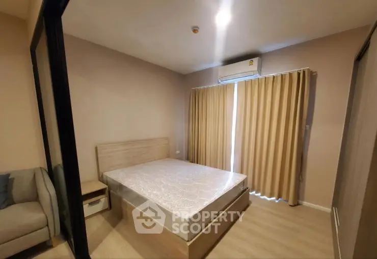 Modern bedroom with natural light, featuring a comfortable bed and stylish decor.