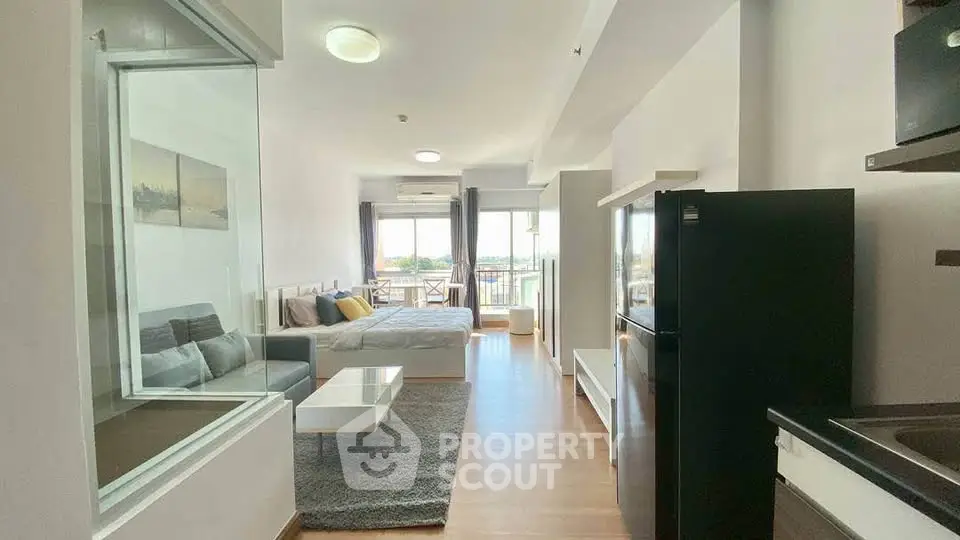 Modern studio apartment with open layout and balcony view