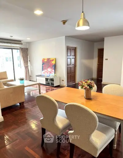 Spacious living and dining area with elegant decor and natural light