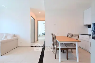 Modern open-plan living and dining area with minimalist design and natural light.