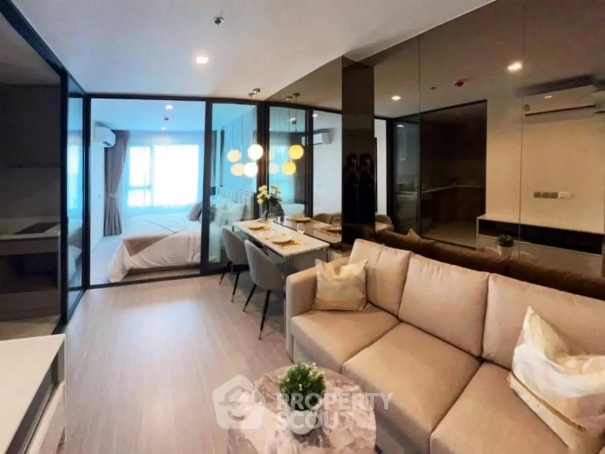 Modern open-plan living room with elegant decor and dining area in a stylish apartment.