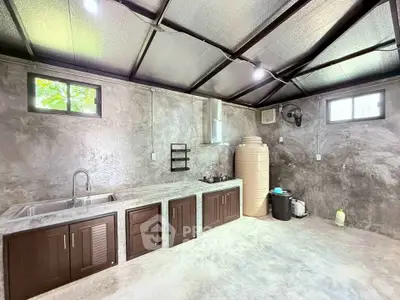 Modern industrial-style kitchen with concrete finishes and open layout