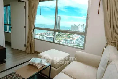 Stunning living room with panoramic city and ocean views, featuring elegant decor and natural light.