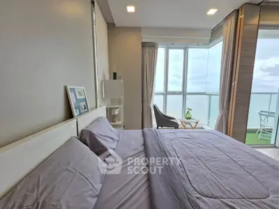 Luxurious bedroom with ocean view and private balcony in modern apartment