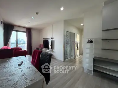 Modern living room with city view, featuring sleek furniture and natural light.