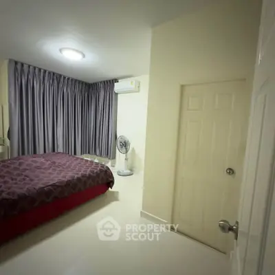 Cozy bedroom with modern air conditioning and elegant curtains, perfect for restful nights.