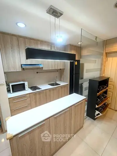 Modern kitchen with sleek wooden cabinets and built-in appliances