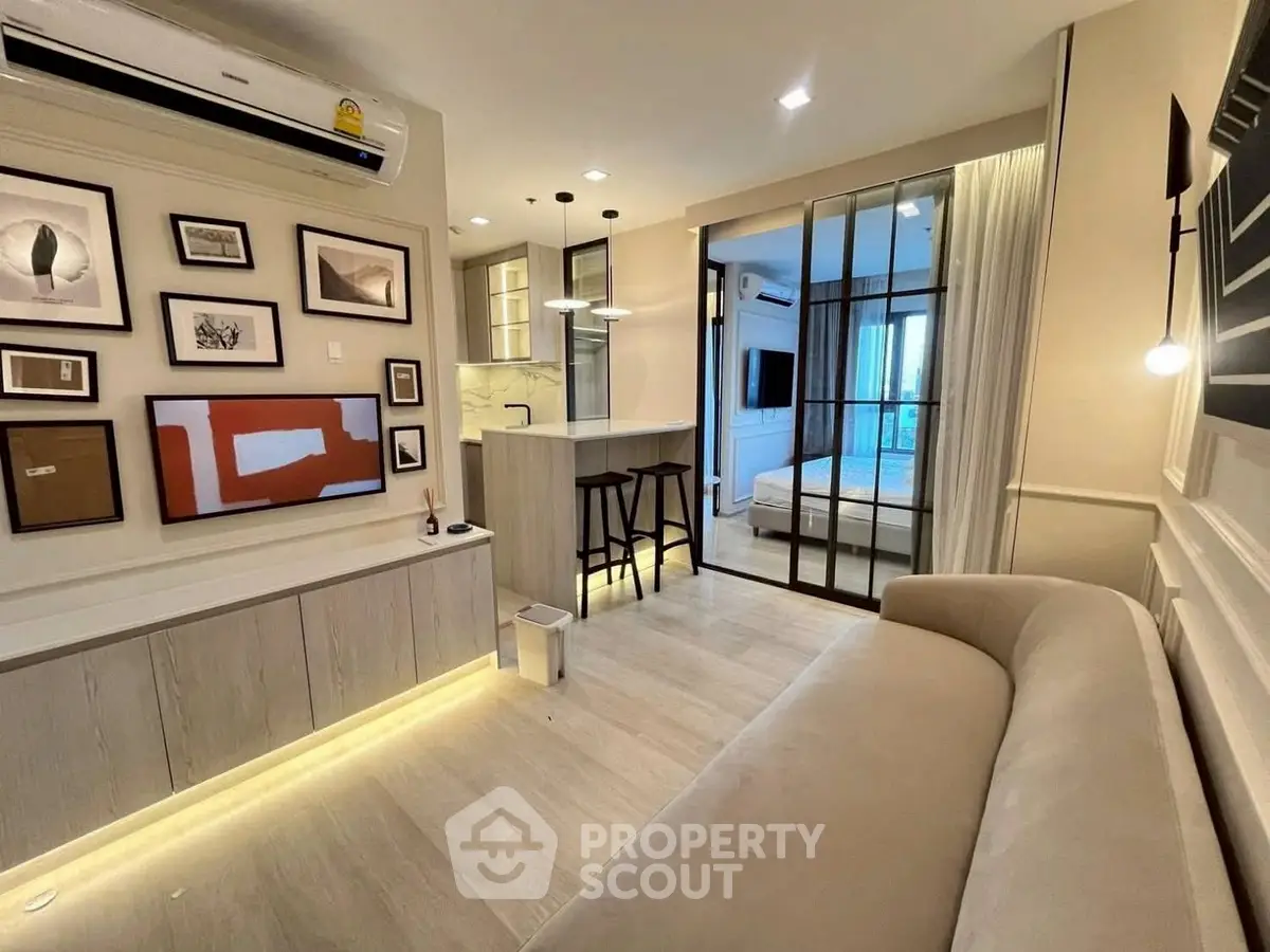 Modern living room with stylish decor and open layout leading to bedroom