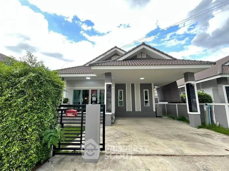 Charming single-story house with modern design and spacious driveway in a serene neighborhood.