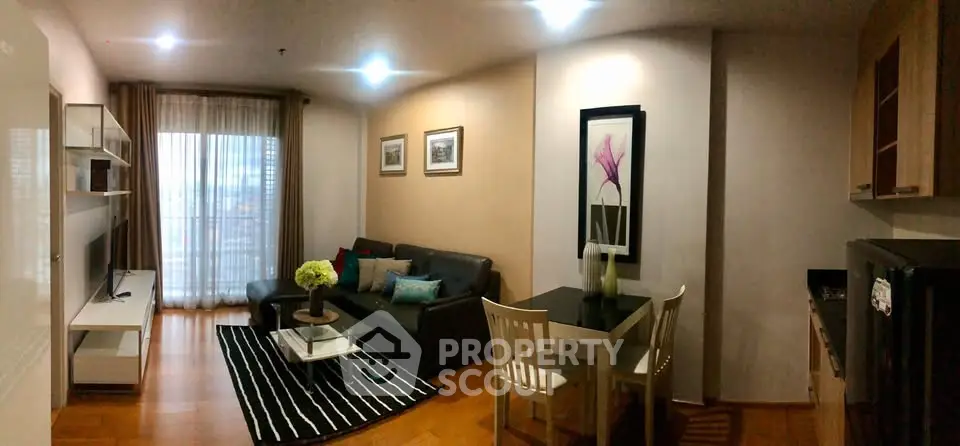 Modern living room with stylish decor and open layout, featuring a cozy seating area and dining space.