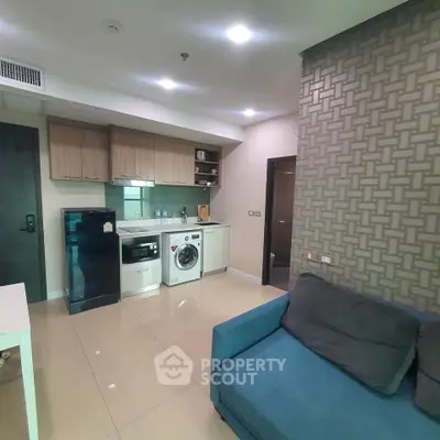 Modern apartment interior with compact kitchen and cozy living area