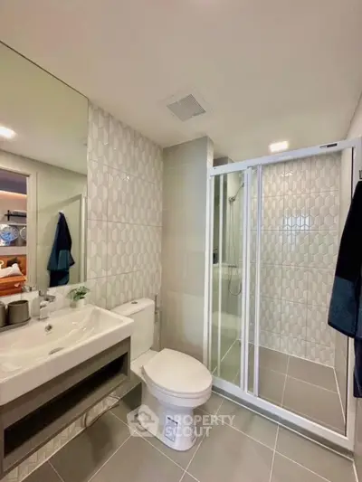 Modern bathroom with glass shower and stylish tile design