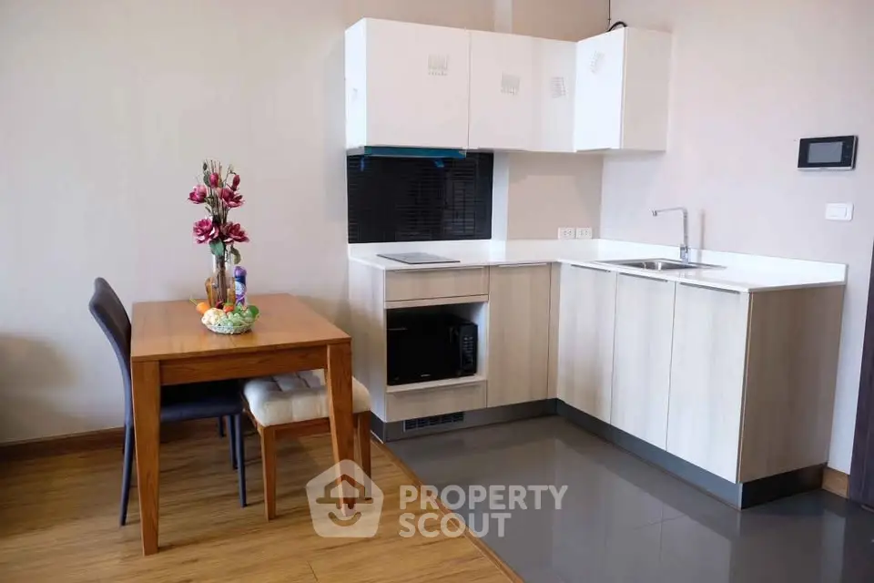 Modern kitchen with sleek cabinets and dining area in a stylish apartment
