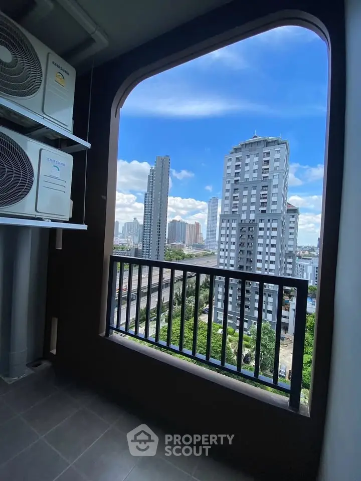 Stunning cityscape view from a modern balcony with sleek railing, perfect for urban living.