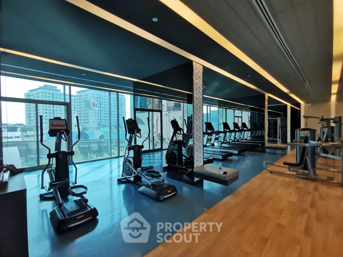 Spacious modern gym with city view and state-of-the-art equipment