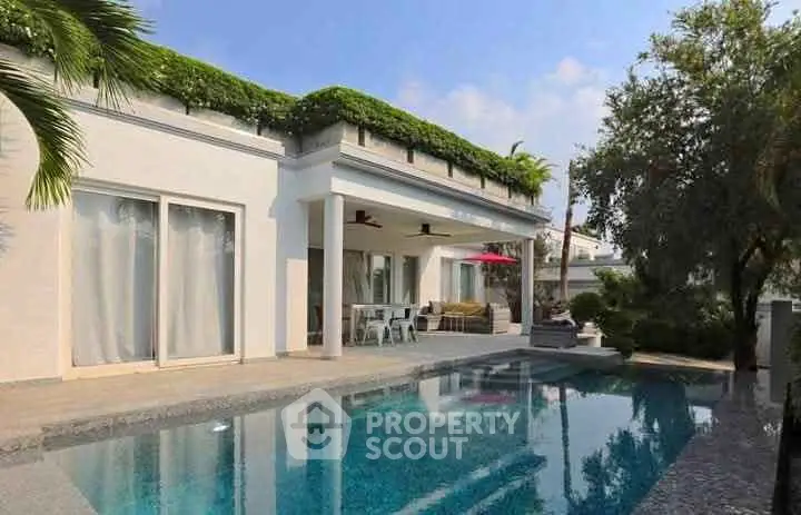 Luxurious villa with private pool and lush greenery, perfect for serene living.