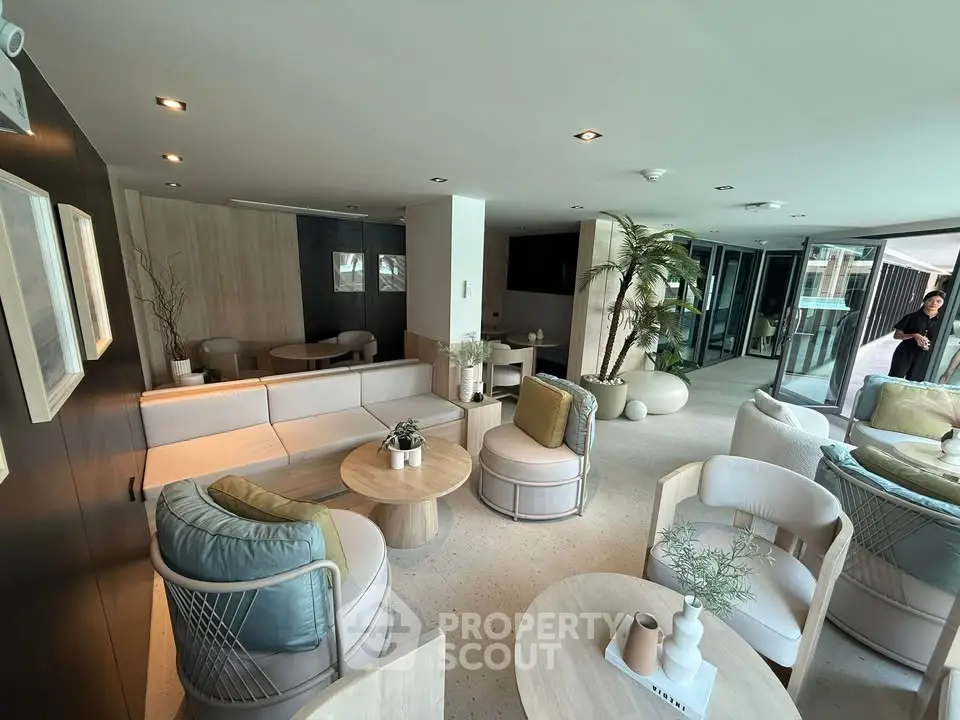 Luxurious modern living room with elegant furniture and large windows offering abundant natural light.