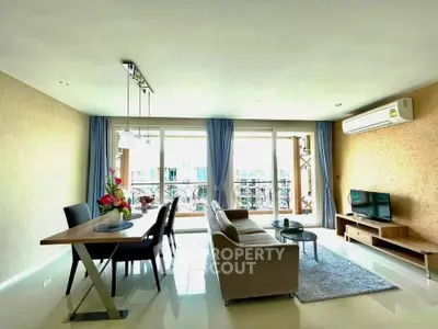 Spacious living room with modern decor and large windows offering natural light.