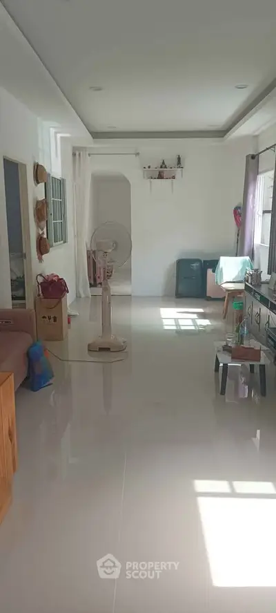 Spacious living room with glossy floors and natural light