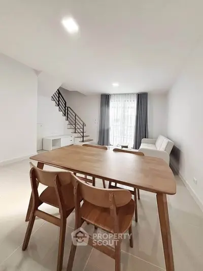 Spacious modern living room with dining area and natural light