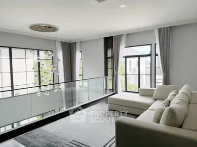 Luxurious modern living room with elegant decor and large windows offering natural light.